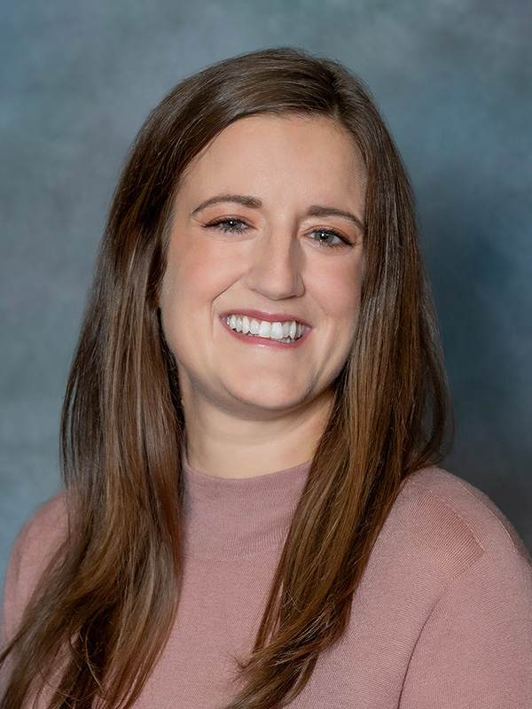 Headshot of Megan Stark, nurse practitioner at South Lake Pediatrics. Megan has long brown hair, is wearing a pink top, and is smiling at the camera.
